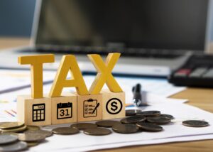 image showing the word tax and coins representing reference to taxes and financial standards